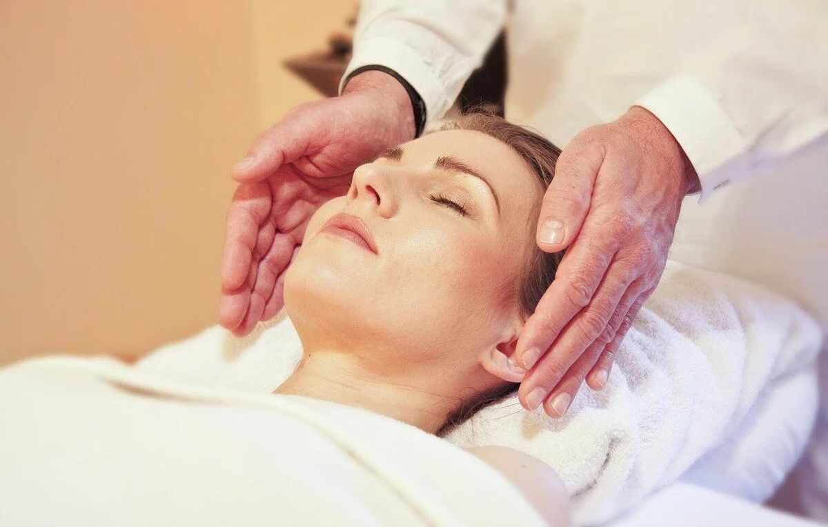 maos-de-homem-aplicando-reiki-em-torno-da-cabeca-de-mulher